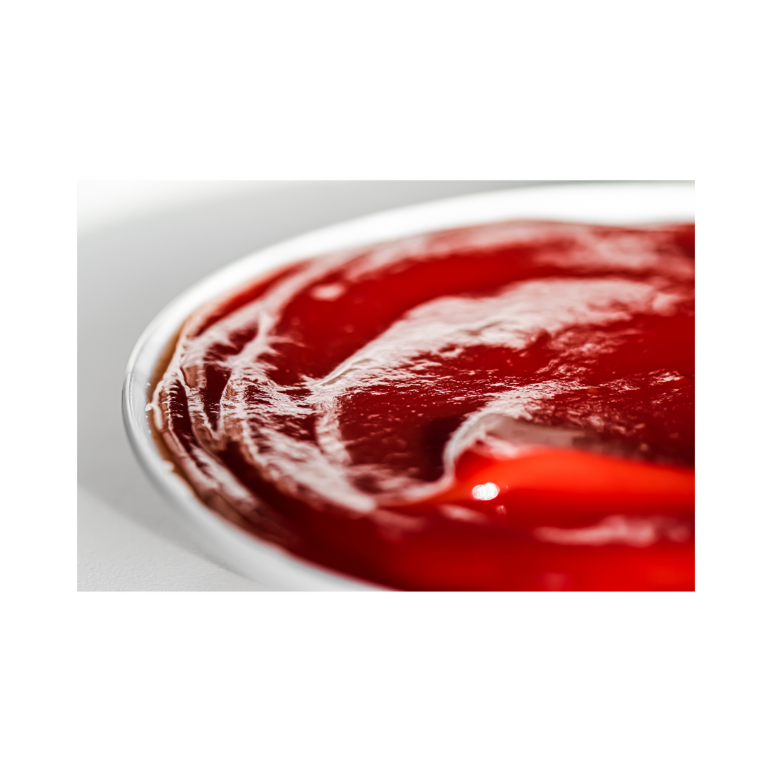 a white bowl filled with homemade red tomato catsup